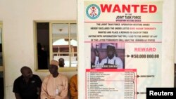 A poster advertising for the search of Boko Haram leader Abubakar Shekau is pasted on a wall in Baga village on the outskirts of Maiduguri, in the north-eastern state of Borno, Nigeria, May 13, 2013. 