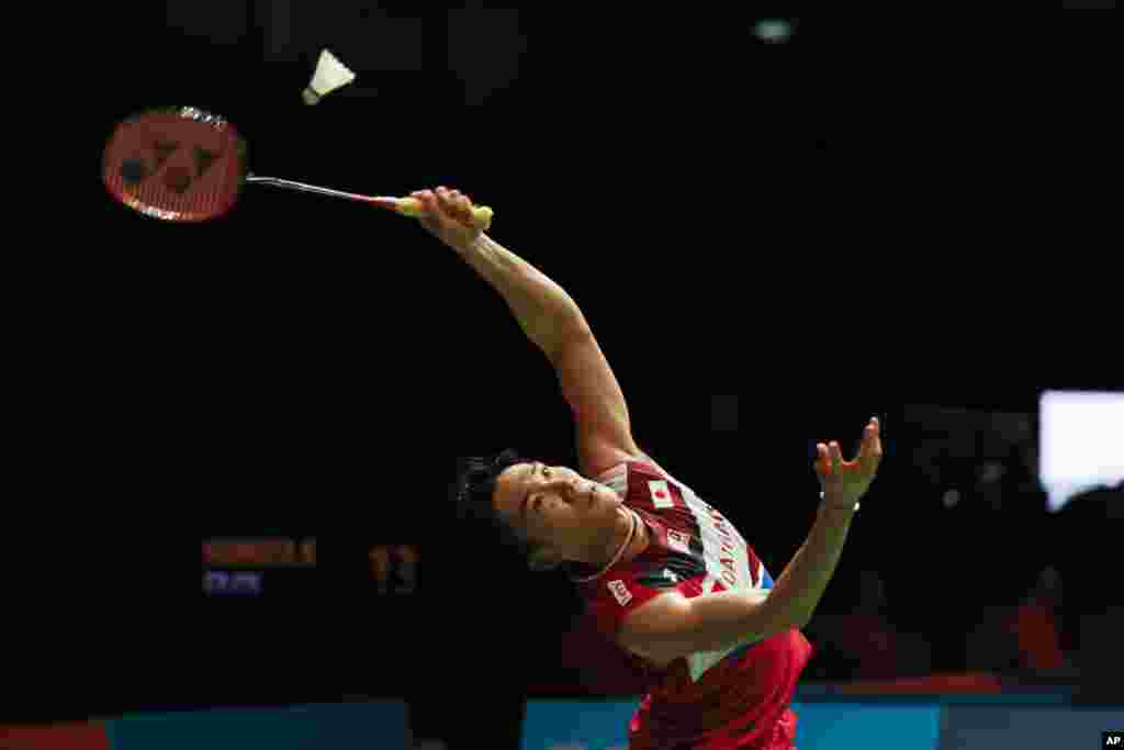 Japan&#39;s Kento Momota hits a return shot against China&#39;s Huang Yu Xiang during Malaysia Master men&#39;s single badminton quarterfinal in Kuala Lumpur, Malaysia.