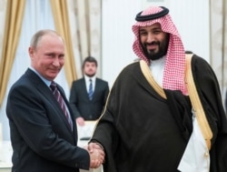 FILE - Russian President Vladimir Putin shakes hands with Saudi Deputy Crown Prince and Defence Minister Mohammed bin Salman during a meeting at the Kremlin in Moscow, Russia, May 30, 2017.