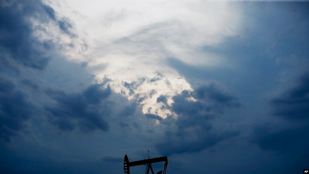 FILE - In this April 21, 2020 file photo, a pumpjack is pictured as a storm moves in Oklahoma City. 