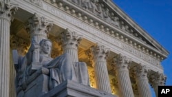 FILE: Light illuminates part of the Supreme Court building on Capitol Hill in Washington, Nov. 16, 2022. 