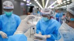 FILE - A medical worker prepares a syringe with a dose of China's Sinovac coronavirus vaccine at the Central Vaccination Center, inside the Bang Sue Grand Station, in Bangkok, Thailand, May 24, 2021.