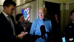 FILE - U.S. President Joe Biden talks to reporters aboard Air Force One during a refueling stop at Ramstein Air Base in Germany on Oct. 18, 2023, as he travels back from Israel to Washington.