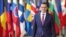 FILE - A Dec. 14, 2017 file photo shows Polish Prime Minister, Mateusz Morawiecki, arriving for an EU summit at the Europa building in Brussels. Poland's new prime minister is looking to improve strained relations with partners in the European Union when he arrives in Brussels on Jan. 9. 2017.