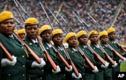 Zimbabwean military turn their heads toward the new president as they parade at the inauguration ceremony of President Emmerson Mnangagwa in the capital Harare, Zimbabwe, Nov. 24, 2017.