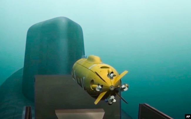In this video grab provided by RU-RTR Russian television via AP television on Thursday, March 1, 2018, a computer simulation shows a Russian nuclear-powered underwater drone being released by a submarine.