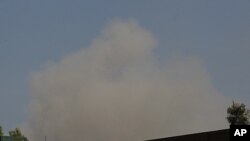 A plume of smoke rises to the sky after an airstrike in Tripoli, Libya, May 28, 2011