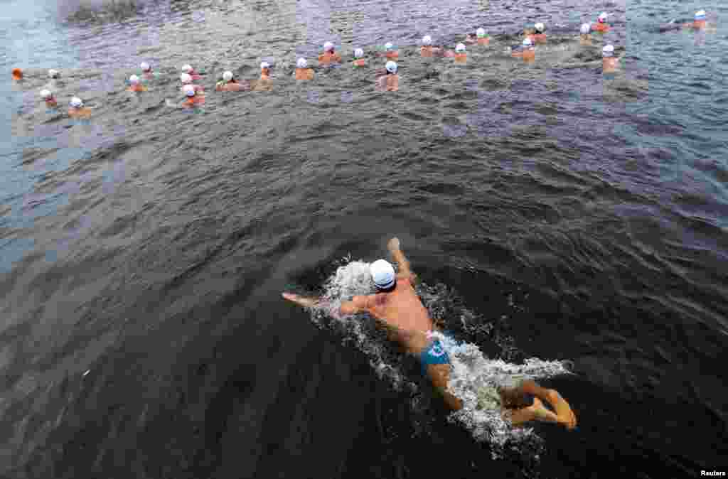 Swimmers participate in the annual Christmas winter swimming competition in the Vltava river in Prague, Czech Republic.