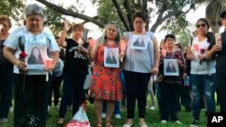 Dozens of family members and friends of four women who authorities say were killed by a U.S. Border Patrol agent gather for a candlelight vigil at a park in downtown Laredo, Texas, on Sept. 18, 2018. 