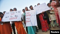 Demonstrators hold placards as they take part in a protest rally in solidarity with a rape victim from New Delhi in Mumbai, December 27, 2012.