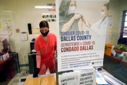 A Dallas County Health and Human Services nurse completes paperwork after administering a Pfizer COVID-19 vaccine at a county-run vaccination site in Dallas, Aug. 26, 2021.