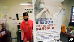 A Dallas County Health and Human Services nurse completes paperwork after administering a Pfizer COVID-19 vaccine at a county-run vaccination site in Dallas, Aug. 26, 2021.