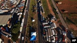 Trucks sit idle during a truckers strike in Brasilia, May 25, 2018. Thousands of Brazilian truckers angry over fuel price hikes blocked roads on Friday, the fifth day of a strike.