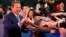 FILE - Actor and former Governor of California Arnold Schwarzenegger shakes hands with Chinese fans as he arrives for the grand opening of the 5th annual Beijing International Film Festival in Beijing, April 16, 2015. 