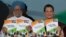 India's Prime Minister Manmohan Singh (L) and Chief of India's ruling Congress party Sonia Gandhi hold their party's manifesto for the April/May general election in New Delhi, March 26, 2014.