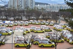 Ambulances are parked to transport patients with mild symptoms of the coronavirus in Daegu, South Korea, March 3, 2020.