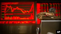 A Chinese investor monitors stock prices at a brokerage house in Bejiing, Dec. 26, 2019. 