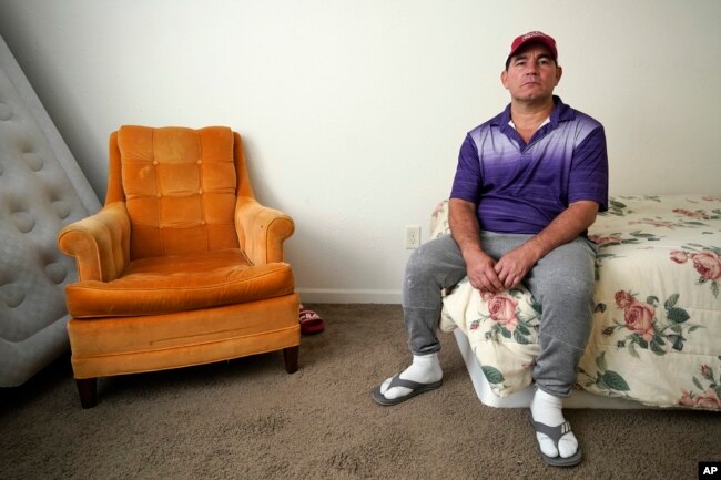 Rolando José Cisneros Borroto in his apartment, Friday, Aug. 26, 2022, in Algona, Iowa. (AP Photo/Charlie Neibergall)