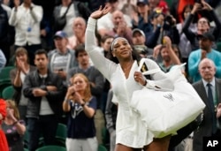 FILE - Serena Williams waves as she leaves the court after losing to France's Harmony Tan in a first round women's singles match on day two of the Wimbledon tennis championships in London, June 28, 2022.