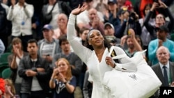 FILE - Serena Williams waves as she leaves the court after losing to France's Harmony Tan in a first round women's singles match on day two of the Wimbledon tennis championships in London, June 28, 2022.