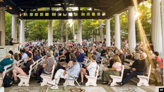 FILE: People gather at an evening vigil for author Salman Rushdie who was attacked, Aug. 12, 2022, in Chautauqua, N.Y. Rushdie was stabbed as he was about to give a lecture at the Chautauqua Institution.