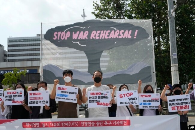 Protesters stage a rally to oppose the joint military exercises between the U.S. and South Korea in front of the presidential office in Seoul, South Korea, Monday, Aug. 22, 2022. (AP Photo/Ahn Young-joon)