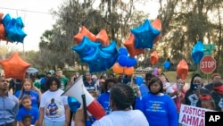 Thea Brooks, an aunt of Ahmaud Arbery, addresses supporters at the intersection where the Black man was fatally shot two years ago, in Brunswick, Ga., Feb. 23, 2022. Three white men who chased and killed Arbery have been convicted of murder and federal ha