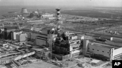 FILE - This 1986 photo shows an aerial view of the Chernobyl nuclear plant in Chernobyl, Ukraine, and damage from an explosion and fire in reactor four on April 26, 1986, that sent large amounts of radioactive material into the atmosphere.