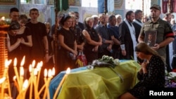 지난 17일 우크라이나 서부 지역에서 거행된 전사자 장례식에서 배우자(오른쪽)와 가족·친지들이 애도하고 있다. (자료사진)