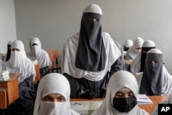 Afghan girls attend a religious school, which remained open since the last year's Taliban takeover, in Kabul, Afghanistan, Aug. 11, 2022.