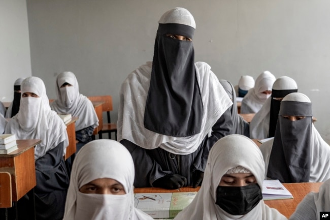 Afghan girls attend a religious school, which remained open since the last year's Taliban takeover, in Kabul, Afghanistan, Aug. 11, 2022.