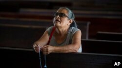 A parishioner says the rosary as she kneels inside the Cathedral in Matagalpa, Nicaragua, Aug. 19, 2022.