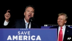 FILE - Wisconsin Republican gubernatorial candidate Tim Michels, left, speaks as former President Donald Trump, right, watches duirng a rally in Waukesha, Wis., on August 5, 2022. On Tuesday, Michels defeated his opponent, according to Edison Research. 