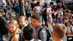 Students are lined up outside of the Adams' campus of Oyster Adams Bilingual School as they wait to check-in for the first day of school, Monday, Aug. 29, 2022 in Washington, DC. (Photo/Pablo Martinez Monsivais)