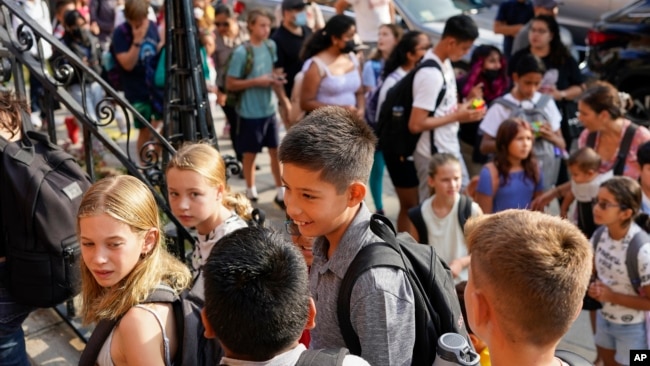 Students are lined up outside of the Adams' campus of Oyster Adams Bilingual School as they wait to check-in for the first day of school, Monday, Aug. 29, 2022 in Washington, DC. (Photo/Pablo Martinez Monsivais)