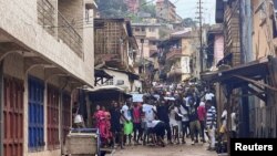 Protesters shout as they face riot police during anti-government protests in Freetown, Sierra Leone, Aug. 10, 2022. 