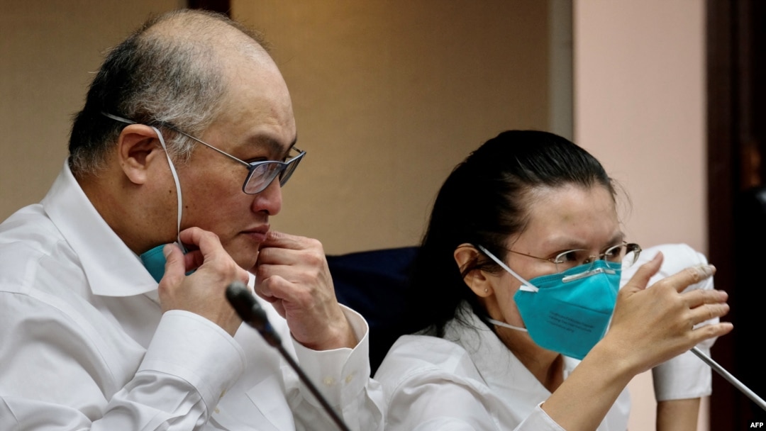 Lee Ming-che (left), a Taiwanese democracy activist who was imprisoned in China for five years, takes part in a press conference with his wife, Lee Ching-yu, at the parliament in Taipei on May 10, 2022.