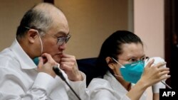 Lee Ming-che (left), a Taiwanese democracy activist who was imprisoned in China for five years, takes part in a press conference with his wife, Lee Ching-yu, at the parliament in Taipei on May 10, 2022.