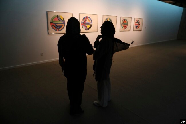 Two women visit a 19th and 20th-century American and European minimalist and conceptual masterpieces show at the Tehran Museum of Contemporary Art in Tehran, Iran, Aug. 2, 2022.