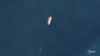 Two vessels identified by TankerTrackers.com as Iranian state-owned Polaris 1 (smaller tanker) and Rhine Shipping DMCC-operated Babel (larger tanker) engage in a ship-to-ship-transfer in waters off Iraq's Al-Faw peninsula, March 19, 2020 (Planet Labs)