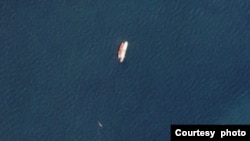 Two vessels identified by TankerTrackers.com as Iranian state-owned Polaris 1 (smaller tanker) and Rhine Shipping DMCC-operated Babel (larger tanker) engage in a ship-to-ship-transfer in waters off Iraq's Al-Faw peninsula, March 19, 2020 (Planet Labs)