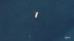 Two vessels identified by TankerTrackers.com as Iranian state-owned Polaris 1 (smaller tanker) and Rhine Shipping DMCC-operated Babel (larger tanker) engage in a ship-to-ship-transfer in waters off Iraq's Al-Faw peninsula, March 19, 2020 (Planet Labs)