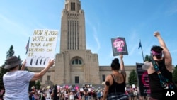 FILE - Protesters line the street around the front of the Nebraska State Capitol during an abortion rights rally held on July 4, 2022, in Lincoln, Neb.