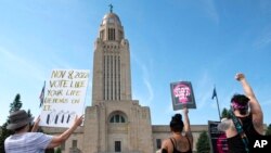 FILE - Protesters line the street around the front of the Nebraska State Capitol during an abortion rights rally held on July 4, 2022, in Lincoln, Neb.