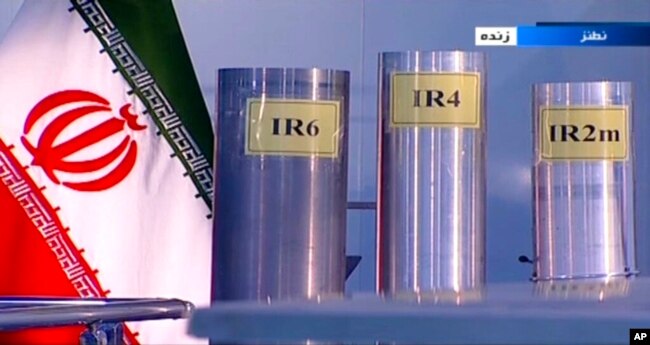 FILE - Three versions of domestically-built centrifuges are shown in a live TV program from Natanz, an Iranian uranium enrichment plant, in Iran, in this June 6, 2018, frame grab from the Islamic Republic Iran Broadcasting state-run TV.