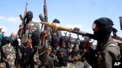 FILE - Armed al-Shabab fighters prepare to travel into the city, just outside the capital of Mogadishu, Somalia, Dec. 8, 2008. Somalia is pushing to have an arms embargo lifted in order to better fight the extremists. The U.N. Security Council is set to vote in November 2022.