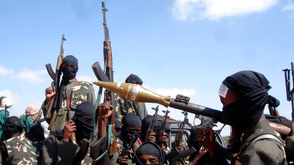 FILE - Armed al-Shabab fighters ride on pickup trucks as they prepare to travel into the city, just outside the capital of Mogadishu, Somalia, Dec. 8, 2008.