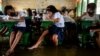 Students attend the first day of in-person classes, at a flooded school due to high tide, in Macabebe, Pampanga province, Philippines, Aug. 22, 2022.