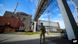 FILE - A Russian serviceman guards an area of the Zaporizhzhia Nuclear Power Station on territory under Russian military control, in southeastern Ukraine, May 1, 2022. 