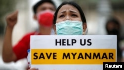 FILE - Myanmar citizens protest against the military coup in front of the UN office in Bangkok, Thailand Feb. 17, 2021.